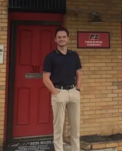 Zach Hayes outside the red door of his office on Main Street in Lowell