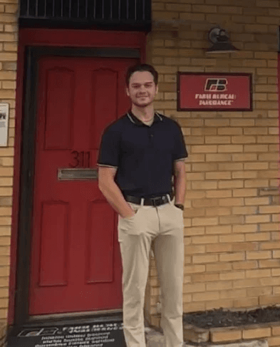 Zach Hayes standing outside the agency office on Main Street in Lowell